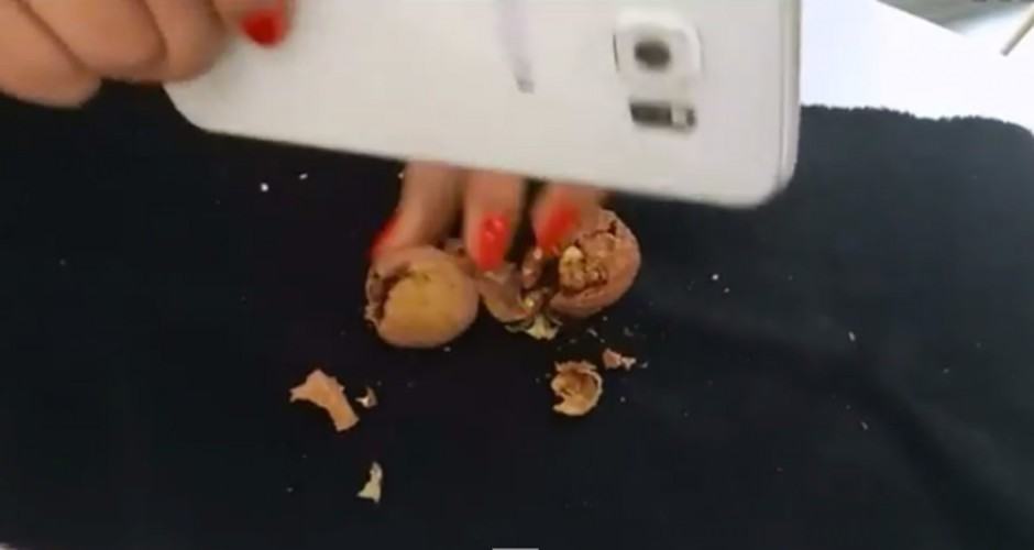 If you only have one Galaxy S6, turn it on its side edge to crack the nuts. Photo: Dark Skill/YouTube